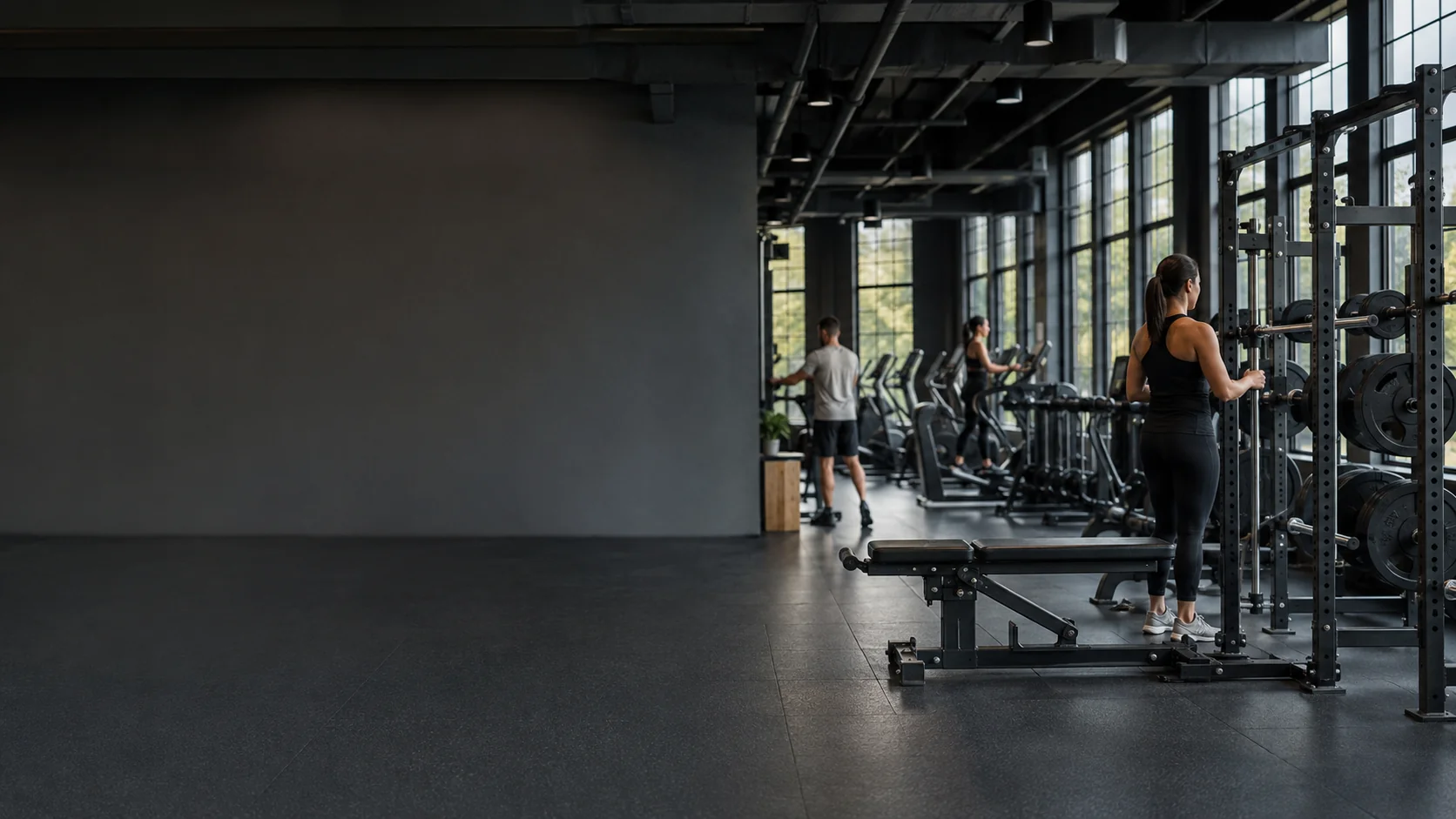Member training at a power rack in a modern gym