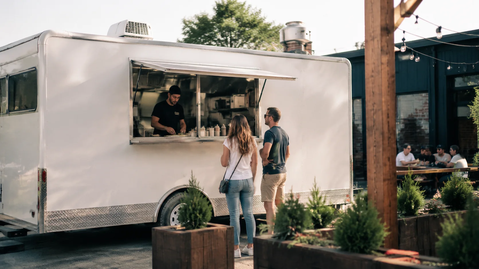 Food truck serving customers with outdoor seating