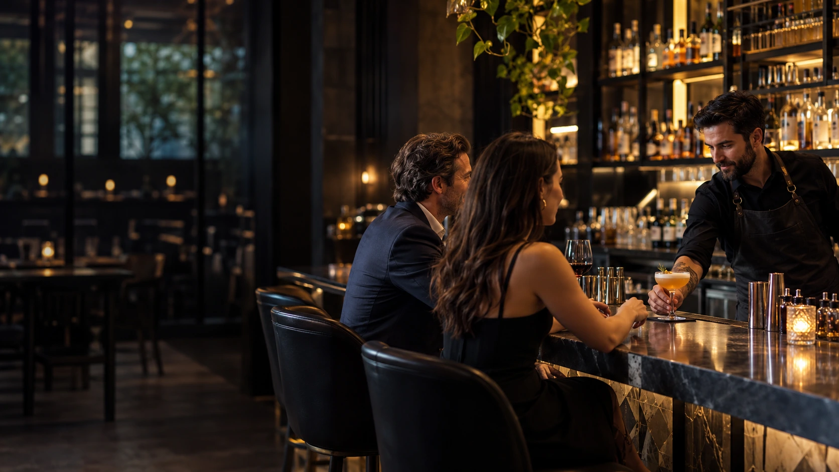 Bartender serving a cocktail to guests at an upscale bar